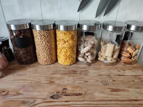a group of five jars filled with different types of food at ShortStopPasilaiciai in Vilnius