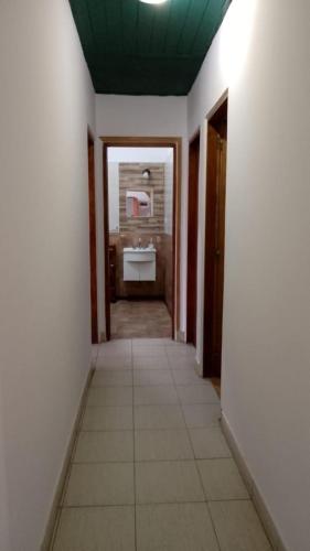 a hallway with a bathroom with a sink in it at Costa Edison in Mar del Plata