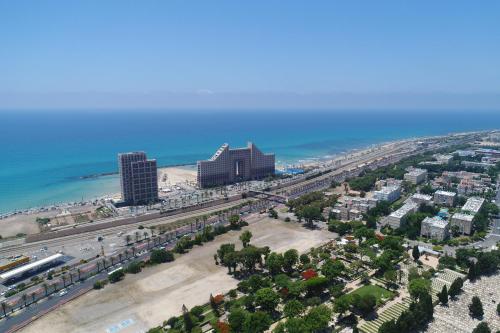 an aerial view of a city and the beach at מגדל הים חיפה in Haifa
