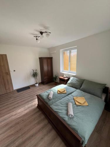 a bedroom with a large bed with two pillows on it at Sládkovičov dvor in Banská Štiavnica