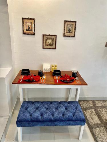a table with a blue bench in a room at Kiamboni in Nakuru