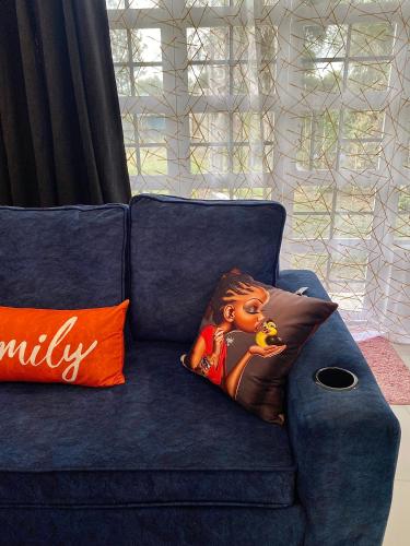a blue couch with a lion pillow on it at Kiamboni in Nakuru