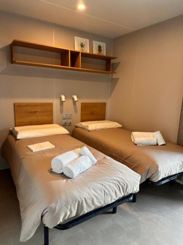 a room with two beds with towels on them at Val di Venere Glamp House in Santa Maria in Stelle