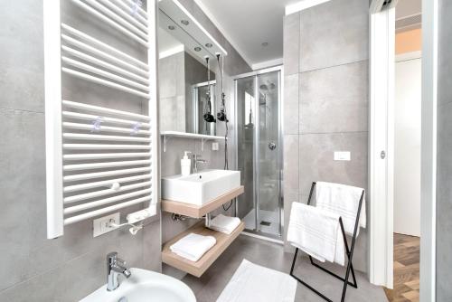 a bathroom with a sink and a toilet and a shower at Marconi House in Mestre