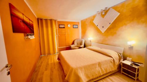 a bedroom with a bed and a chair in it at Castelpetroso Bed&Food in Castelpetroso