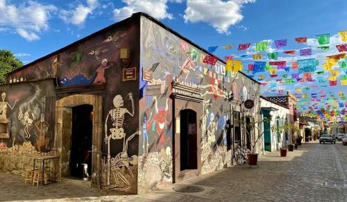 a building with a mural on it on a street at Cómoda y amplia Habitación en Jalatlaco in Oaxaca City