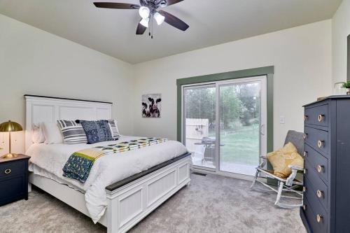 a bedroom with a bed and a ceiling fan at The Chicken Coop in Troy