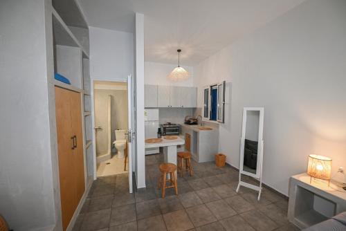 a kitchen with a table and chairs in a room at Fabio Studios in Kionia