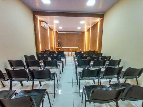 an empty room with chairs and a table in it at Pousada Rio Claro in Poconé