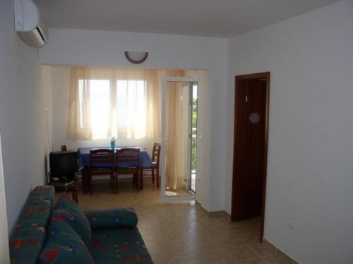 a living room with a couch and a table at Villa Maja original since 2005 in Baška Voda