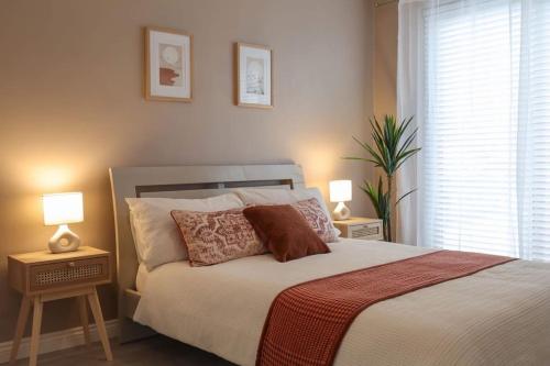 a bedroom with a large bed with two night stands at Modern 2 bed apartment at the Mournes in Newcastle