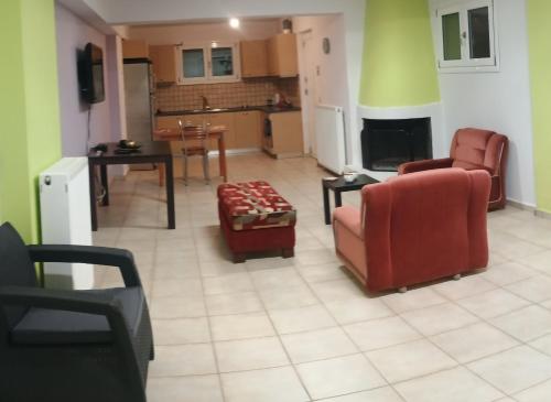 a living room with two chairs and a table at Sophia apartment in Dhrépanon