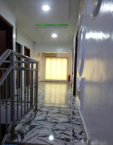 a hallway with a tile floor in a building at Kemi hotel in Ikeja