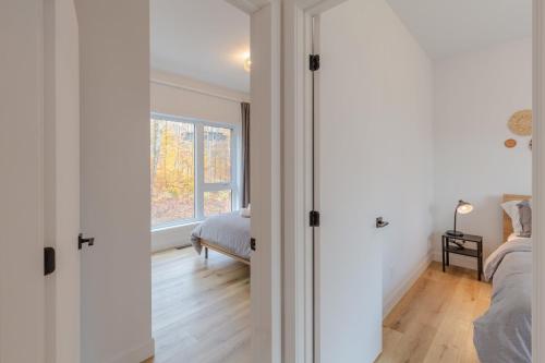 a bedroom with white walls and a bed and a window at Mountain View Retreat with Private Hot Tub & Pool in La Conception