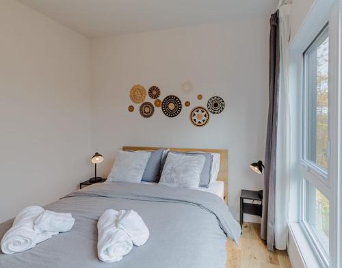 a bedroom with a bed with towels on it at Mountain View Retreat with Private Hot Tub & Pool in La Conception