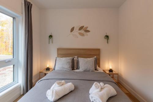 a bedroom with a bed with towels on it at Mountain View Retreat with Private Hot Tub & Pool in La Conception