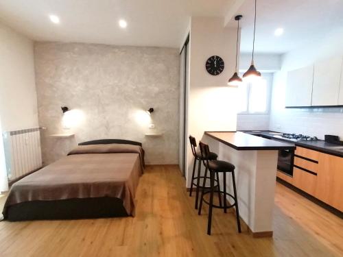 a bedroom with a bed and a small kitchen at Urban Loft in Lido di Ostia