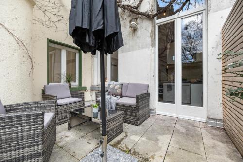 a patio with two chairs and an umbrella at APARTVIEW Apartments Krefeld - WLAN - Zentral - ruhig in Krefeld