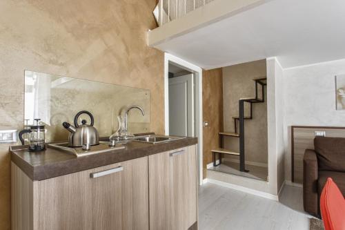 a kitchen with a sink and a counter top at Pia Domus in Rome