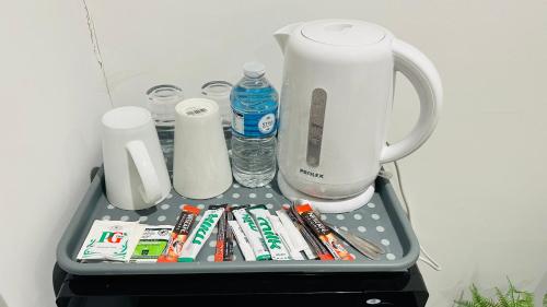 a tray with toothbrushes toothpaste and a blender at COSY AND COMFY DOUBLE ROOM in London