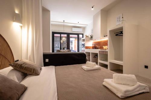a bedroom with a large bed with towels on it at Suite de lujo estilo mediterráneo in Valencia