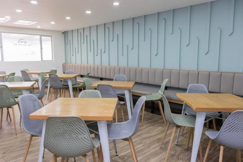 an empty classroom with tables and chairs at Hotel Bacata Plaza in Zipaquirá