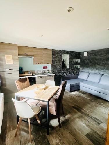une cuisine et un salon avec une table et un canapé dans l'établissement Spa privatif à Bray-Dunes, à Bray-Dunes