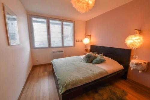 a bedroom with a bed with two pillows on it at Marché Arago (3min), plage (8min), jardin clos. in Les Sables-dʼOlonne