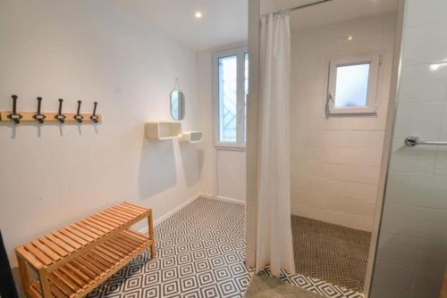 a bathroom with a shower and a bench in it at Marché Arago (3min), plage (8min), jardin clos. in Les Sables-dʼOlonne