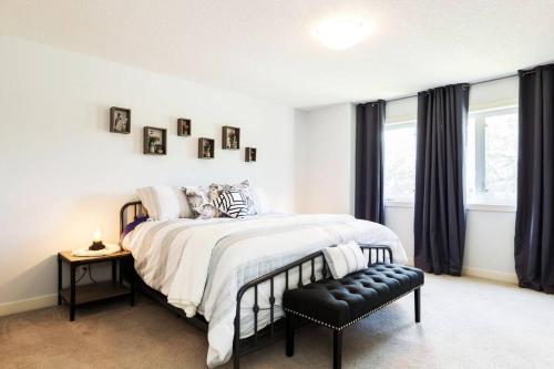 a bedroom with a large bed and a window at Modern Home - King Bed - Garage - Long Stays in Edmonton