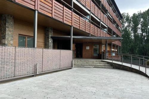 a large building with a fence in front of it at Fantástico apartamento con vistas a Llivia in Llivia