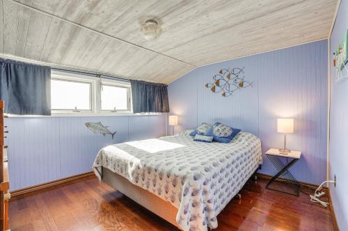 a blue bedroom with a bed and a window at Delton Lake House with Boat Dock Fish, Swim and More! in Orangeville