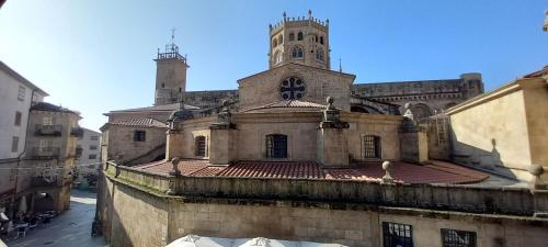 an old building with a tower and a church at “Casa abella “ in La Magdalena
