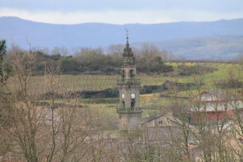a clock tower in the middle of a field at “Casa abella “ in La Magdalena