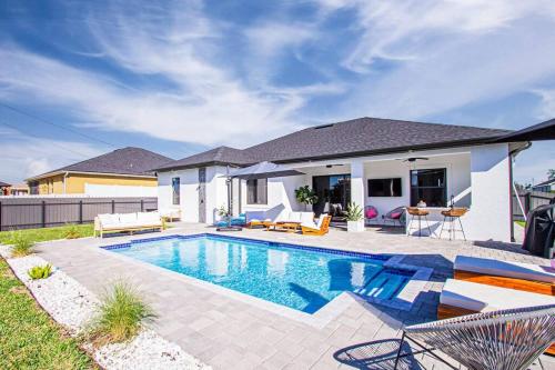 a swimming pool in the backyard of a house at Casa Capri - Heated Pool in Cape Coral