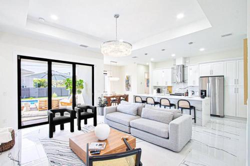 a living room with a couch and a table at Casa Capri - Heated Pool in Cape Coral