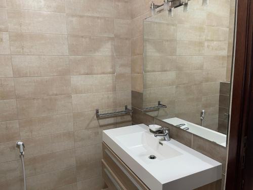 a bathroom with a sink and a mirror at Horizon 2 Cozy Villa in Amman