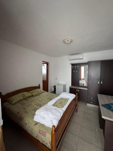a bedroom with a bed and a desk in it at Vila Cano in Durrës