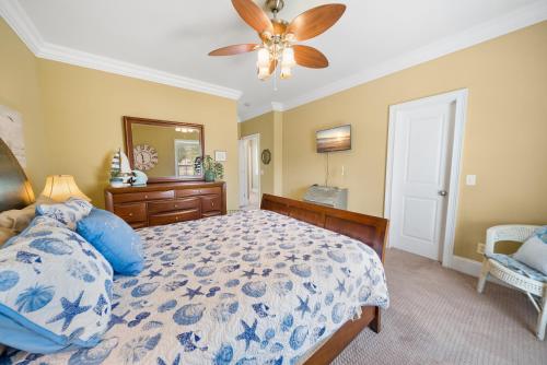 a bedroom with a bed and a ceiling fan at Summer Special, Lux 4BR House Sleeps 12, Pool, Elevator, King bed in Panama City Beach