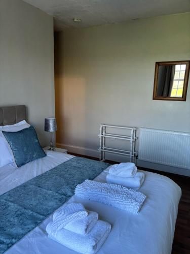 a bedroom with two beds with towels on them at The Old Postie Bed & Breakfast in Annesley