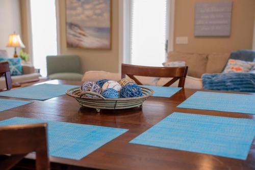 a table with a basket of balls on top of it at Summer Special, Lux 4BR House Sleeps 12, Pool, Elevator, King bed in Panama City Beach