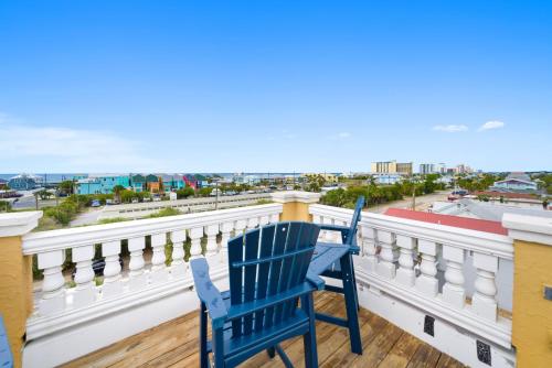 a blue chair on a balcony with a view of the city at Summer Special, Lux 4BR House Sleeps 12, Pool, Elevator, King bed in Panama City Beach