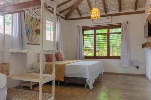 Un dormitorio con una cama y una escalera en una habitación en Pariri Suites, en Trancoso