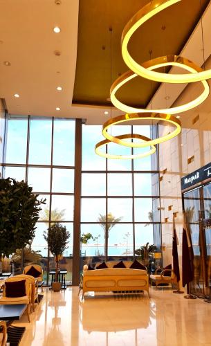 a large lobby with a large window and a large chandelier at Beachfront Home with Sea View - 2BR, 134m2 in Lusail