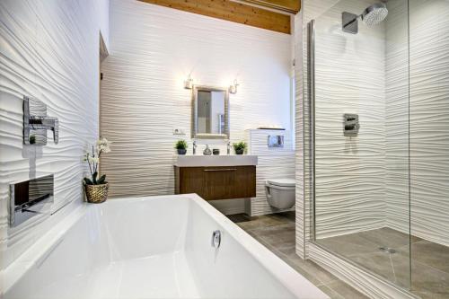 une salle de bain avec une baignoire, un lavabo et des toilettes dans l'établissement Résidence Martre Des Pins - Chalet Martre des Pins - 12 Personnes - Morzine MAE-3841, à Morzine