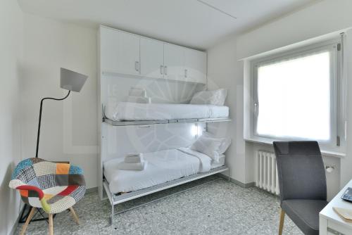 a room with two bunk beds and a chair at Le Lion Apartments - Bike & Ski in Aosta