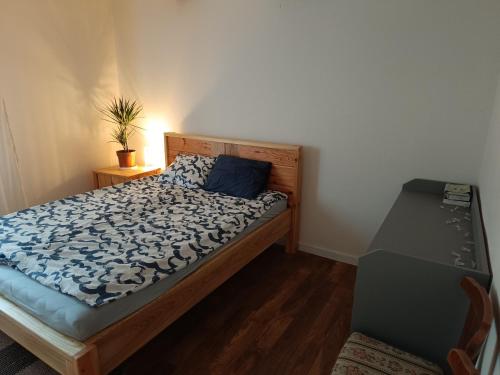 a bedroom with a bed with a blue comforter at Dom całoroczny in Wojsławice
