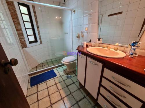 a bathroom with a sink and a shower and a toilet at CAMBOINHAS BnB in Niterói