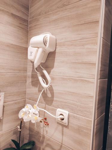 a white phone on a wall in a bathroom at Studio Ocean in Paralia Dionysiou