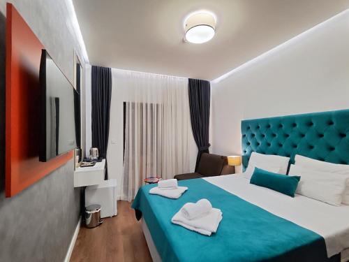 a hotel room with a bed with towels on it at Lolo Luxury rooms & suites in Budva